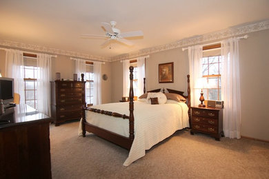 Photo of a large traditional master bedroom in Milwaukee with grey walls, carpet and no fireplace.