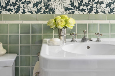 Example of a small classic green tile and ceramic tile ceramic tile, single-sink, wallpaper and beige floor bathroom design in San Francisco with a two-piece toilet, white walls, a console sink and a freestanding vanity