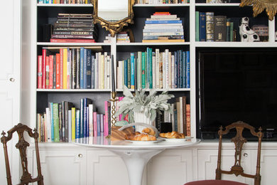 Design ideas for an eclectic family room in New York with a library, black walls and a built-in media wall.