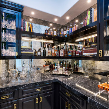 High-gloss black cabinets in a home bar and butler's pantry