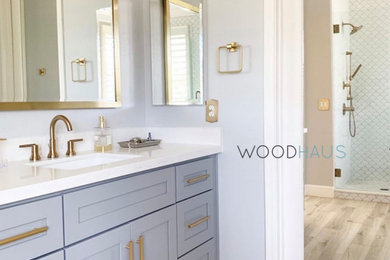 Example of a mid-sized trendy master beige tile and ceramic tile wood-look tile floor, beige floor, double-sink, vaulted ceiling and wall paneling bathroom design in Miami with shaker cabinets, turquoise cabinets, a one-piece toilet, beige walls, an undermount sink, quartzite countertops, a hinged shower door, white countertops and a freestanding vanity