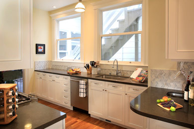 Inspiration for a mid-sized transitional galley medium tone wood floor kitchen remodel in San Francisco with an undermount sink, quartz countertops, marble backsplash, stainless steel appliances and beaded inset cabinets