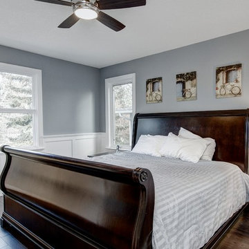 Master bedroom with wainscot paneling and new windows.
