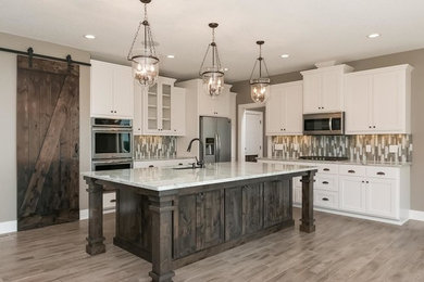Inspiration for a craftsman l-shaped light wood floor open concept kitchen remodel in Minneapolis with shaker cabinets, white cabinets, stainless steel appliances, an island, granite countertops, multicolored backsplash, matchstick tile backsplash and a double-bowl sink