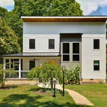Modern Farmhouse Exterior with Yellow Door and Metal Roof