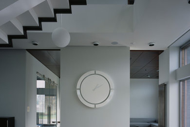 Mid-sized 1960s open concept concrete floor and gray floor living room photo in San Francisco with white walls and a two-sided fireplace