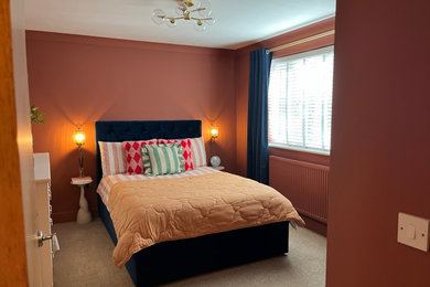 Inspiration for a contemporary master bedroom in Manchester with red walls, carpet and beige floors.