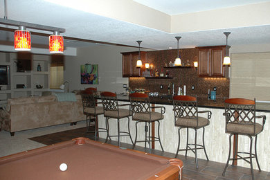 Example of a large single-wall ceramic tile seated home bar design in Denver with a drop-in sink, raised-panel cabinets, dark wood cabinets, tile countertops, multicolored backsplash and mosaic tile backsplash
