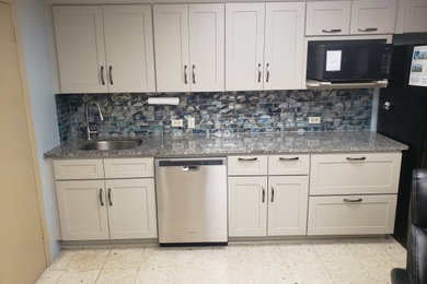 Example of a small trendy single-wall kitchen design in Austin with shaker cabinets and granite countertops