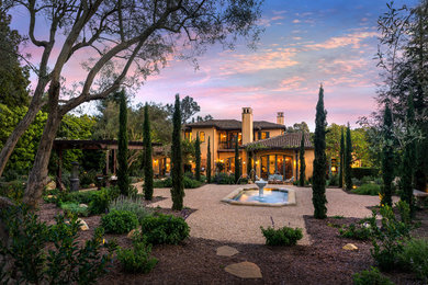 Design ideas for a large mediterranean full sun backyard gravel landscaping in Santa Barbara for summer.