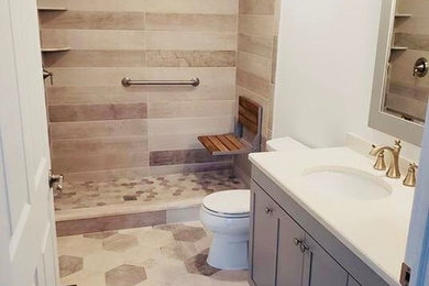 Bathroom - mid-sized transitional 3/4 beige tile, brown tile and stone tile travertine floor and multicolored floor bathroom idea in New York with shaker cabinets, gray cabinets, an undermount sink, quartz countertops, white countertops, a two-piece toilet and beige walls