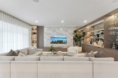 Inspiration for a large transitional enclosed medium tone wood floor and wood wall living room remodel in Orlando with a bar, white walls, no fireplace and a media wall