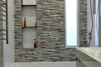 Inspiration for a small modern master multicolored tile brown floor alcove bathtub remodel in San Francisco with flat-panel cabinets, a wall-mount toilet, an integrated sink and dark wood cabinets