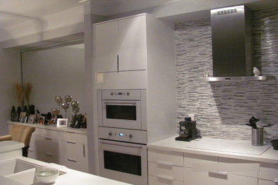 Small u-shaped ceramic tile eat-in kitchen photo in Miami with a double-bowl sink, flat-panel cabinets, yellow cabinets, quartz countertops, gray backsplash, metal backsplash, white appliances and an island