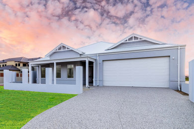 This is an example of a large one-storey white house exterior in Perth with a metal roof, a white roof and a hip roof.