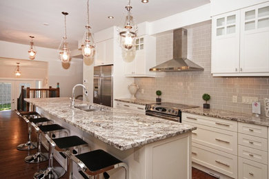 Eat-in kitchen - mid-sized transitional single-wall medium tone wood floor eat-in kitchen idea in Calgary with a double-bowl sink, white cabinets, granite countertops, stainless steel appliances and an island