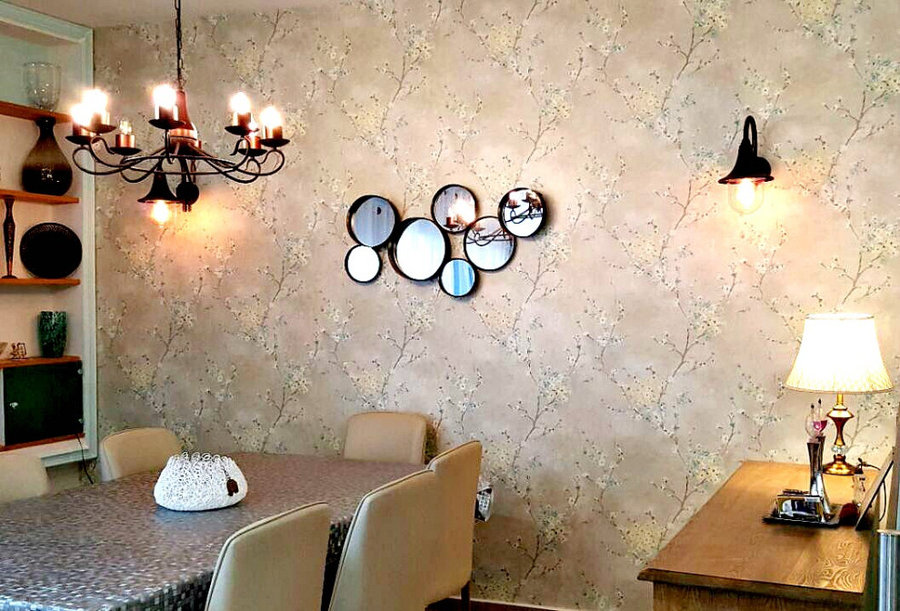 dining room with amazing wallpaper/ bronze lights/wall mirrors