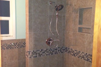 Transitional brown tile and porcelain tile porcelain tile bathroom photo in Portland with green walls