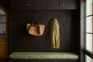 Example of a mid-sized transitional travertine floor and gray floor entryway design in DC Metro with brown walls
