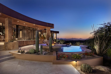 Pool landscaping - mid-sized southwestern backyard natural pool landscaping idea in Phoenix