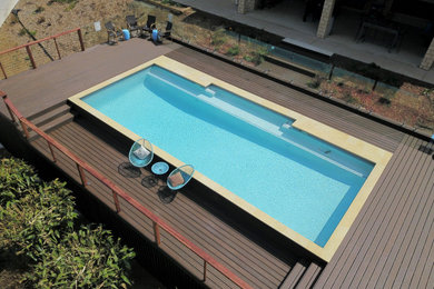 Large backyard rectangular pool in Brisbane with concrete pavers.