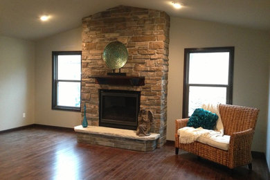 Mid-sized elegant open concept dark wood floor living room photo in Cedar Rapids with beige walls, a standard fireplace, a stone fireplace and a wall-mounted tv