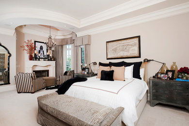 Huge transitional master carpeted bedroom photo in Denver with beige walls, a standard fireplace and a stone fireplace