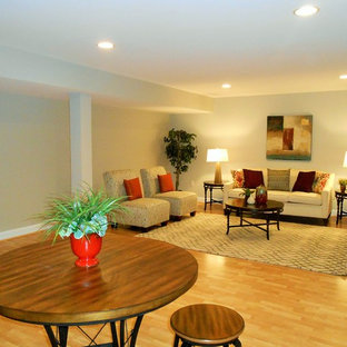 Large traditional fully buried basement in DC Metro with beige walls and light hardwood flooring.