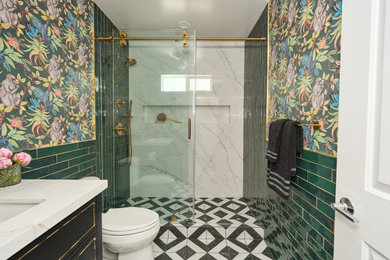 Mid-sized eclectic 3/4 green tile and ceramic tile ceramic tile, multicolored floor, single-sink and wallpaper sliding shower door photo in Orange County with beaded inset cabinets, black cabinets, a one-piece toilet, green walls, a drop-in sink, quartzite countertops, white countertops and a freestanding vanity