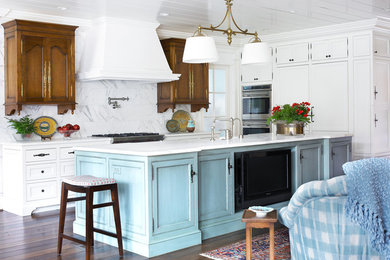 Elegant dark wood floor open concept kitchen photo in Atlanta with recessed-panel cabinets, white cabinets, white backsplash, a farmhouse sink, stone tile backsplash and stainless steel appliances