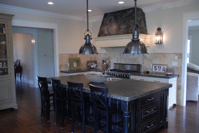 Mid-sized country l-shaped dark wood floor and brown floor eat-in kitchen photo in Other with white cabinets, beige backsplash, stone tile backsplash, an island, a drop-in sink, raised-panel cabinets, soapstone countertops and stainless steel appliances