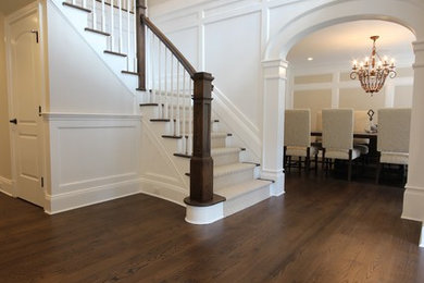 Entryway - large transitional dark wood floor entryway idea in New York with a dark wood front door and white walls