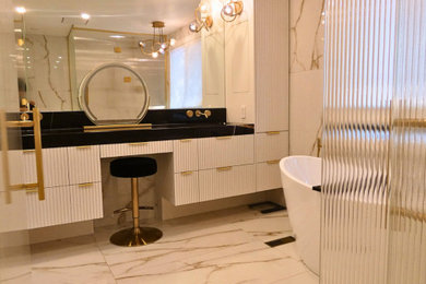 Inspiration for a large contemporary multicolored tile and porcelain tile porcelain tile, multicolored floor and double-sink bathroom remodel in Toronto with white cabinets, a one-piece toilet, multicolored walls, an undermount sink, marble countertops, a hinged shower door and a floating vanity