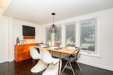 Photo of a small modern separate dining room in Chicago with white walls and dark hardwood floors.