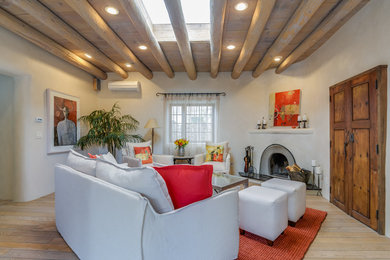 Southwest dark wood floor living room photo in Albuquerque with white walls and a corner fireplace