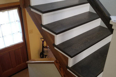 Inspiration for a transitional wood u-shaped staircase in Sacramento with painted wood risers and wood railing.