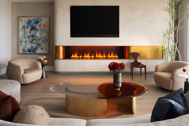 Example of a trendy light wood floor and beige floor living room design in Miami with beige walls, a ribbon fireplace and a wall-mounted tv