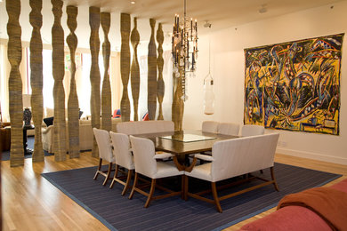 Great room - mid-sized contemporary light wood floor great room idea in New York with beige walls and no fireplace