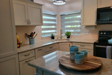 Eat-in kitchen - small l-shaped eat-in kitchen idea in Orlando with shaker cabinets, white cabinets and an island