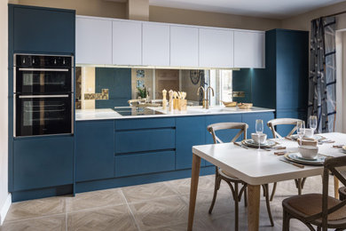 Mid-sized modern galley eat-in kitchen in Other with an integrated sink, flat-panel cabinets, blue cabinets, metallic splashback, mirror splashback, black appliances, no island, brown floor and white benchtop.