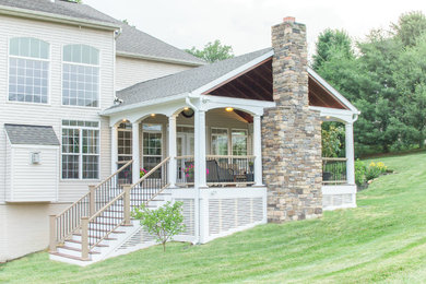 Deck - large transitional backyard deck idea in Baltimore with a fire pit and a roof extension