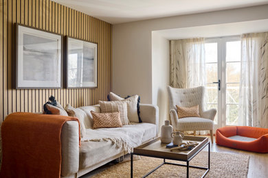 This is an example of a classic living room in Other with beige walls, medium hardwood flooring, brown floors and wood walls.