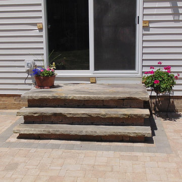 Patio with Natural Stone Steps, Seating Wall, and low voltage lighting