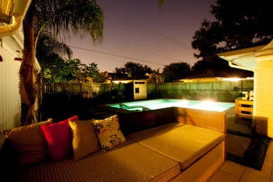 Inspiration for a mid-sized 1960s backyard tile patio remodel in Houston with a fire pit and an awning