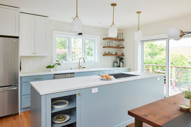 Inspiration for a mid-sized midcentury single-wall eat-in kitchen in Seattle with an undermount sink, shaker cabinets, blue cabinets, white splashback, porcelain splashback, stainless steel appliances, medium hardwood floors, with island and white benchtop.