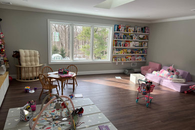 Example of a mid-sized classic girl light wood floor kids' room design in Philadelphia with beige walls