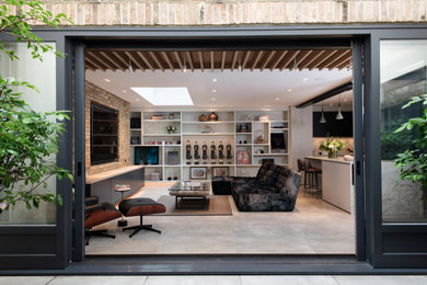 Medium sized contemporary living room in London with concrete flooring and grey floors.