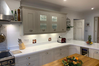 Inspiration for a mid-sized traditional open plan kitchen in Other with shaker cabinets, grey cabinets, quartzite benchtops, stainless steel appliances, medium hardwood floors and grey benchtop.