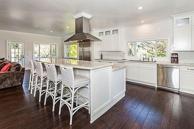 Example of a large transitional galley dark wood floor eat-in kitchen design in San Francisco with an undermount sink, shaker cabinets, white cabinets, marble countertops, white backsplash, subway tile backsplash and stainless steel appliances