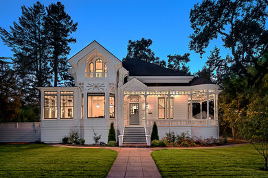 Example of a huge ornate white two-story wood house exterior design in San Francisco with a shingle roof